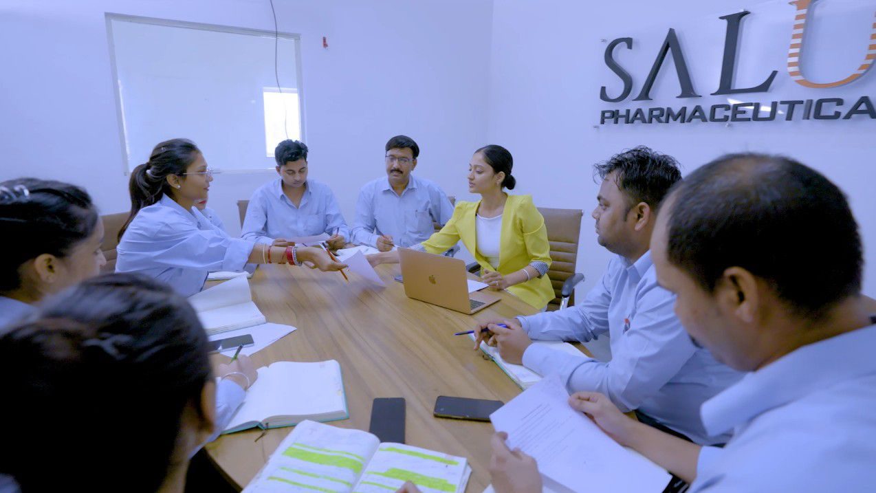 Salus Pharmaceuticals team in a discussion in the company conference room